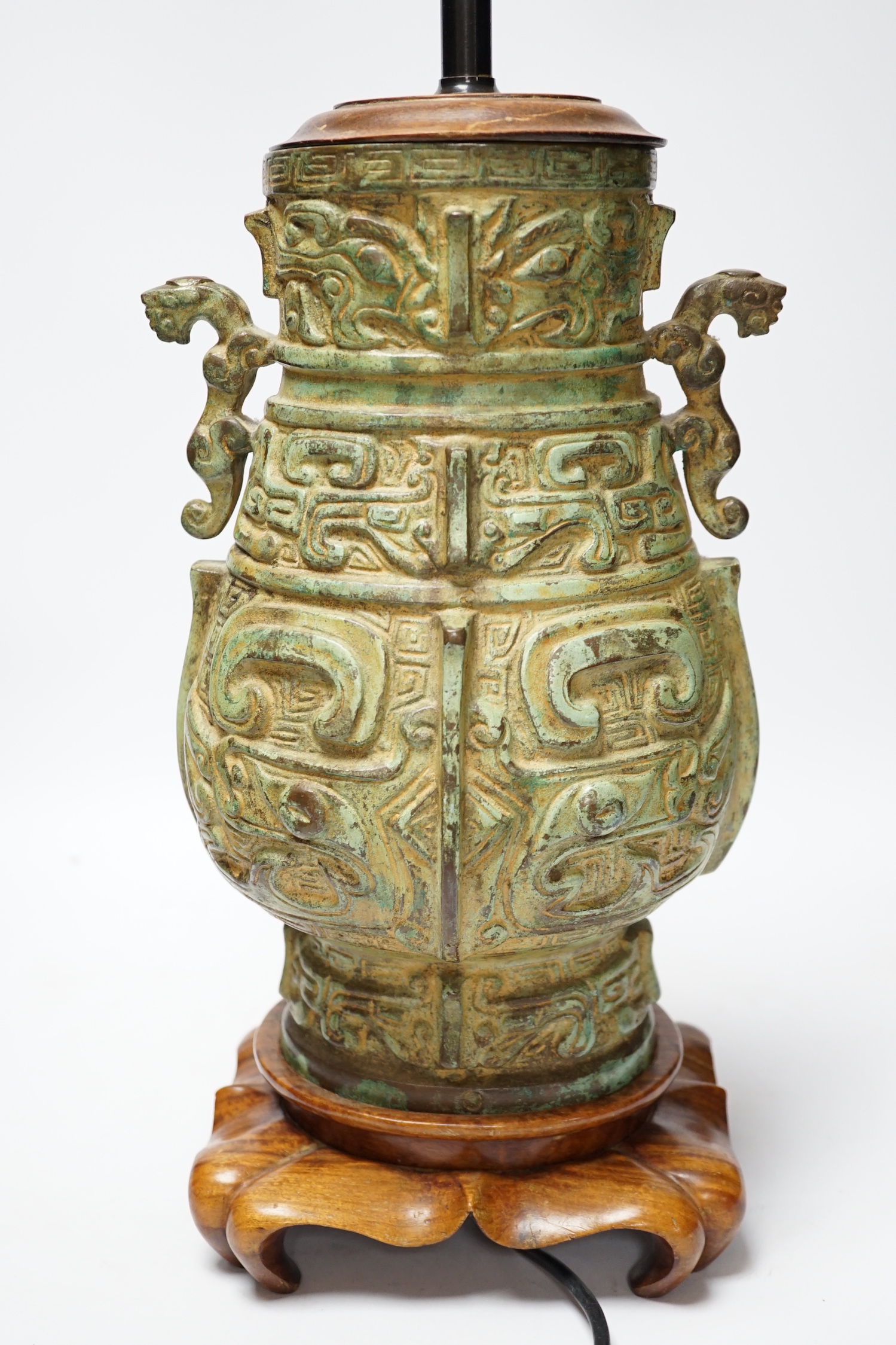 A Chinese archaistic bronze table lamp on stand 36cm high